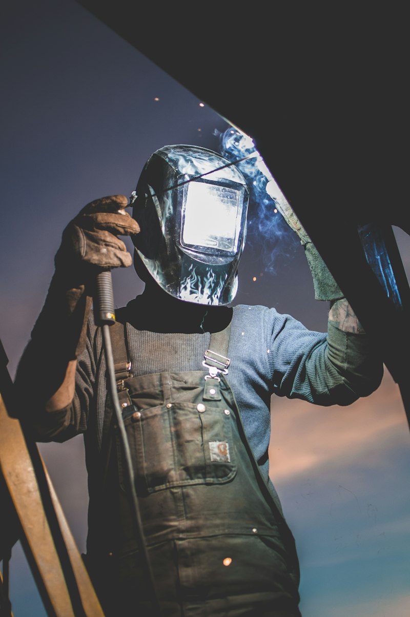Welder wearing an auto-darkening helmet