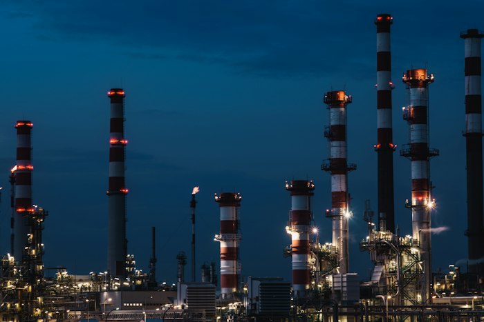 Refinery tower lit up at night