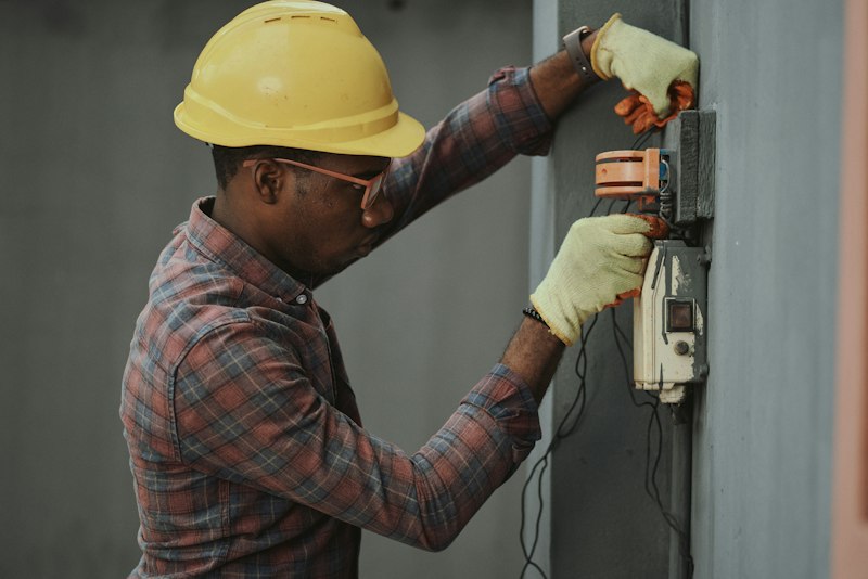 Engineer in a hard hat checking an installation