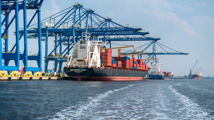 Cargo vessel alongside port cranes
